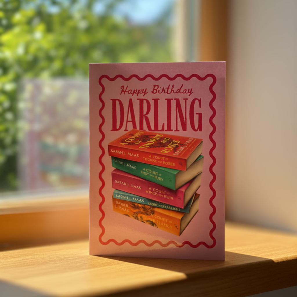 Birthday card with book stack design and ‘happy birthday darling’ text on a sunny windowsill