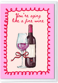 Card with wine bottle and glass illustration and text 'You're aging like a fine wine' on pink background