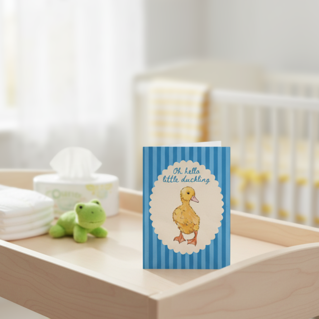 New baby card with a duck illustration on a shelf in a nursery