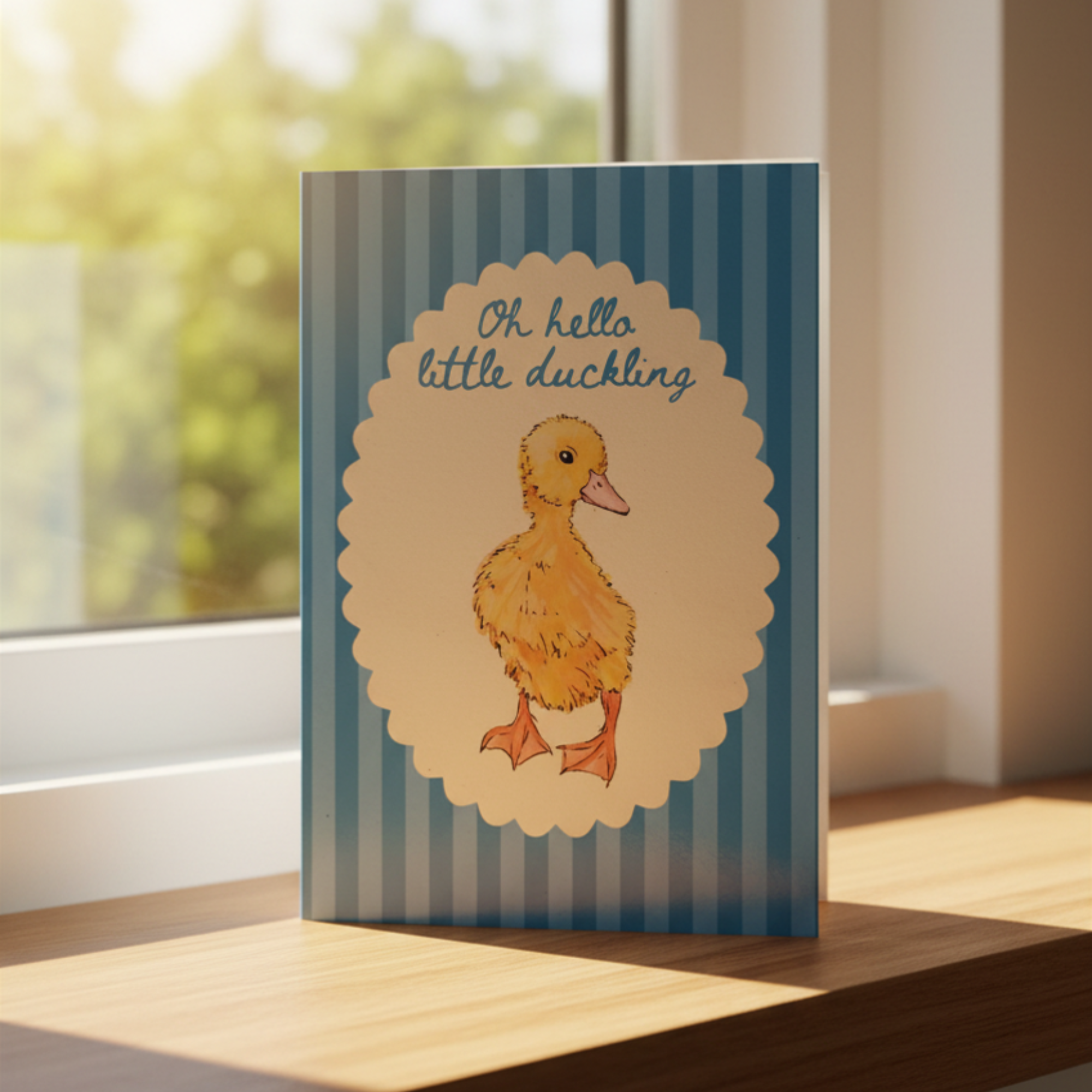 Card with a duck illustration and text on a striped background, placed on a surface near a window.