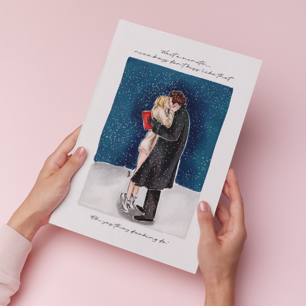 Art print of couple kissing in the snow with a quote saying ‘wait a minute, nice boys don’t kiss like that’ and ‘oh yes they fucking do’