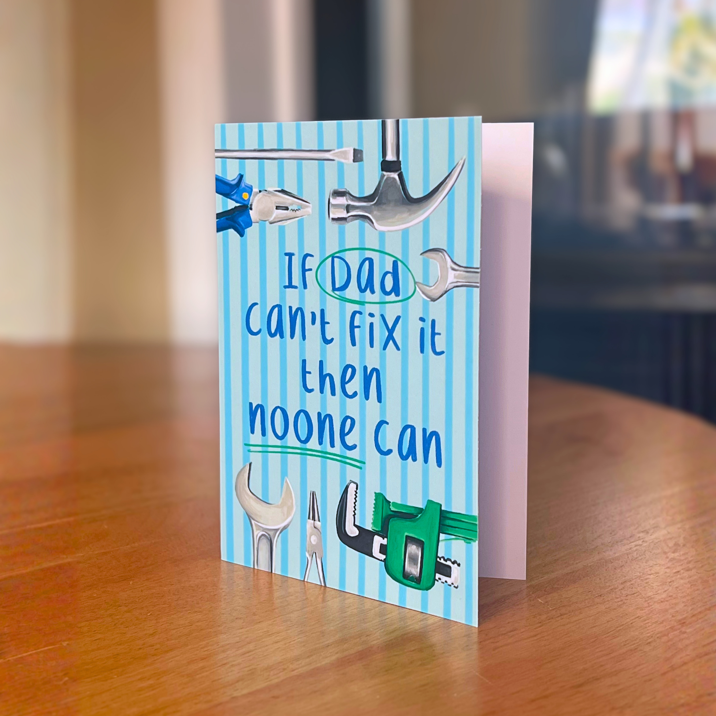 Fathers day card with tools and text on a wooden surface