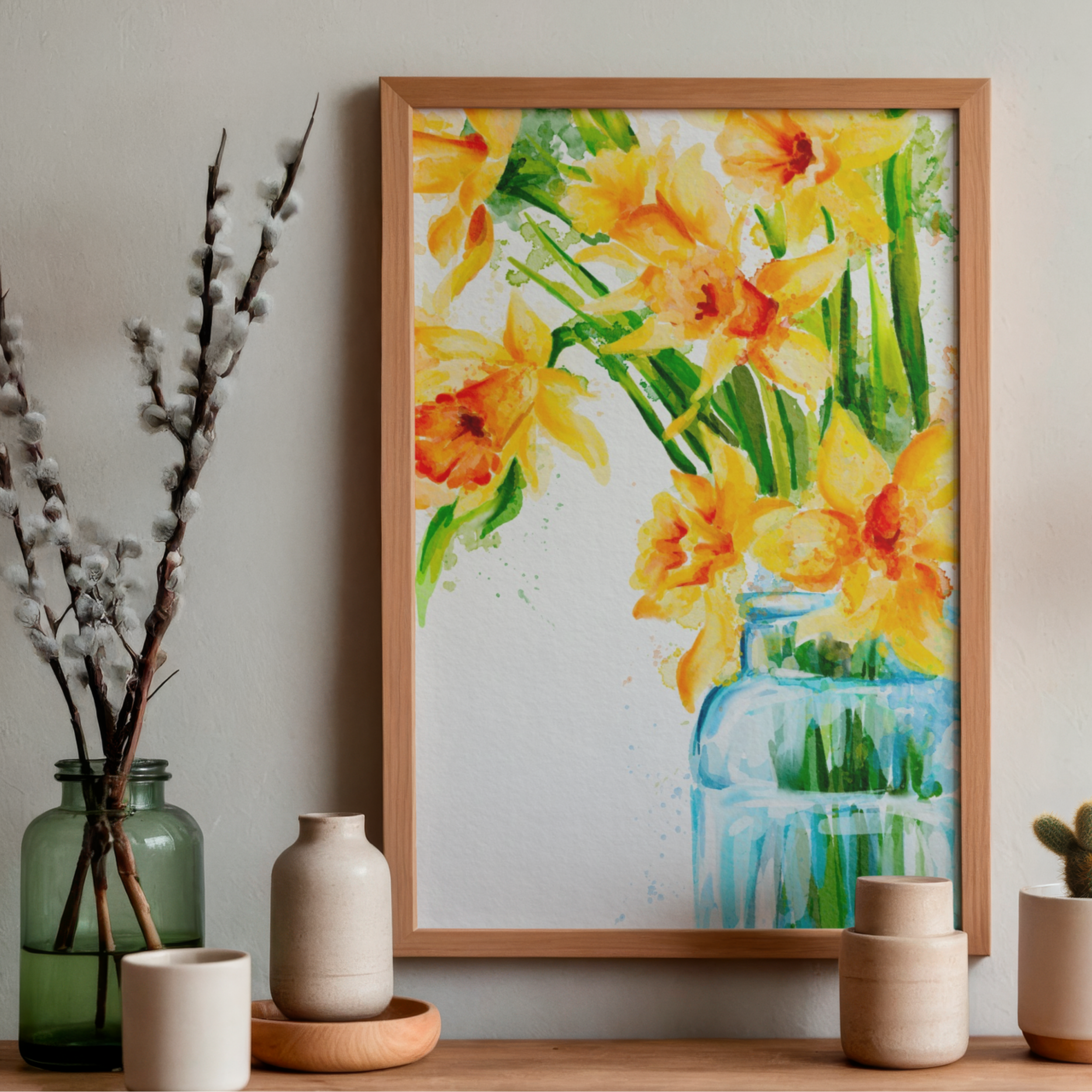 Framed artwork of yellow daffodil flowers on a wall with decorative vases below.