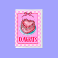 A pink congratulations card featuring an illustration of a cherry cake with the words 'You are engaged!' and the word 'CONGRATS' in bold pink letters, shown against a light purple background.