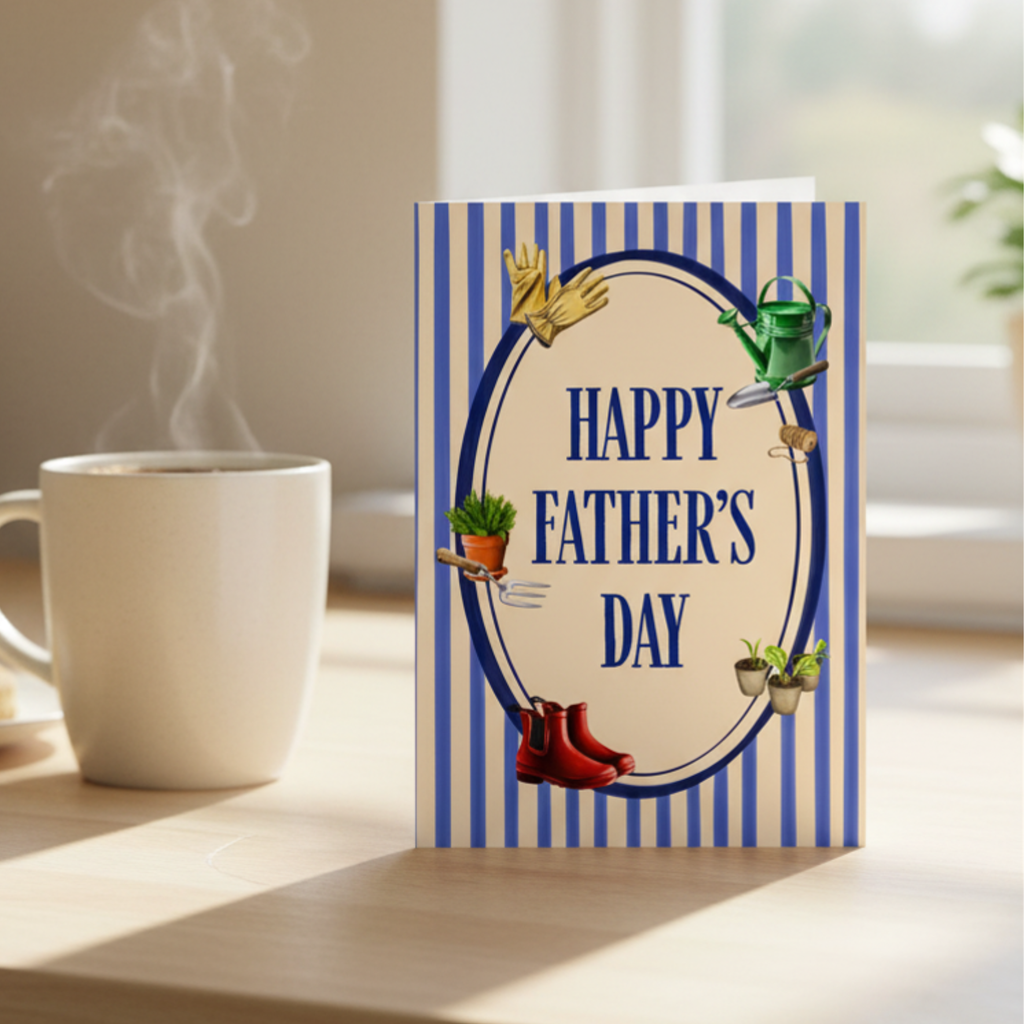 Father's Day card with gardening tools and plants on a striped background. Displayed on a sunny kitchen counter with a mug of tea.