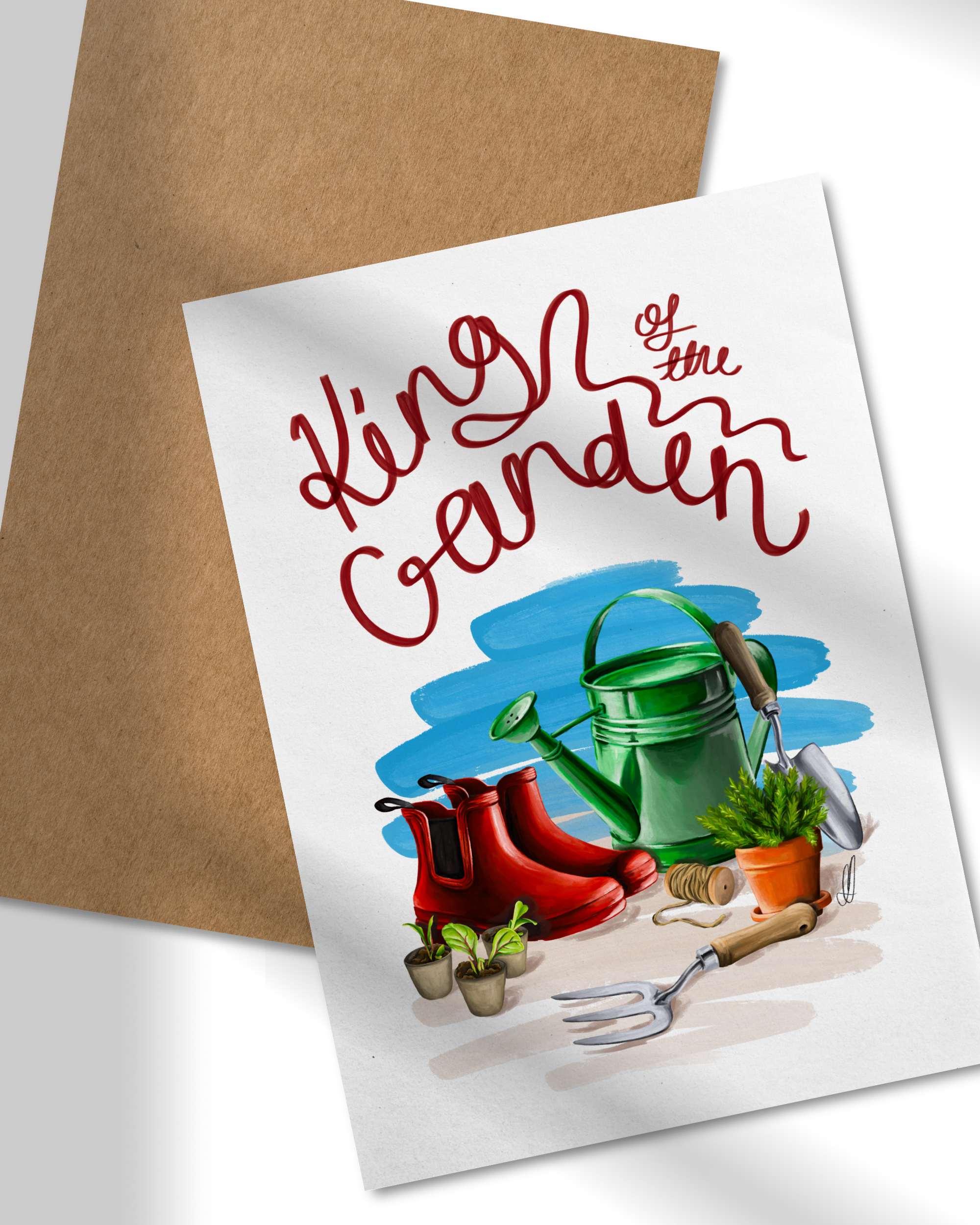 Greeting card with gardening-themed illustration and 'King of the Garden' text, placed on a white surface with a brown envelope.