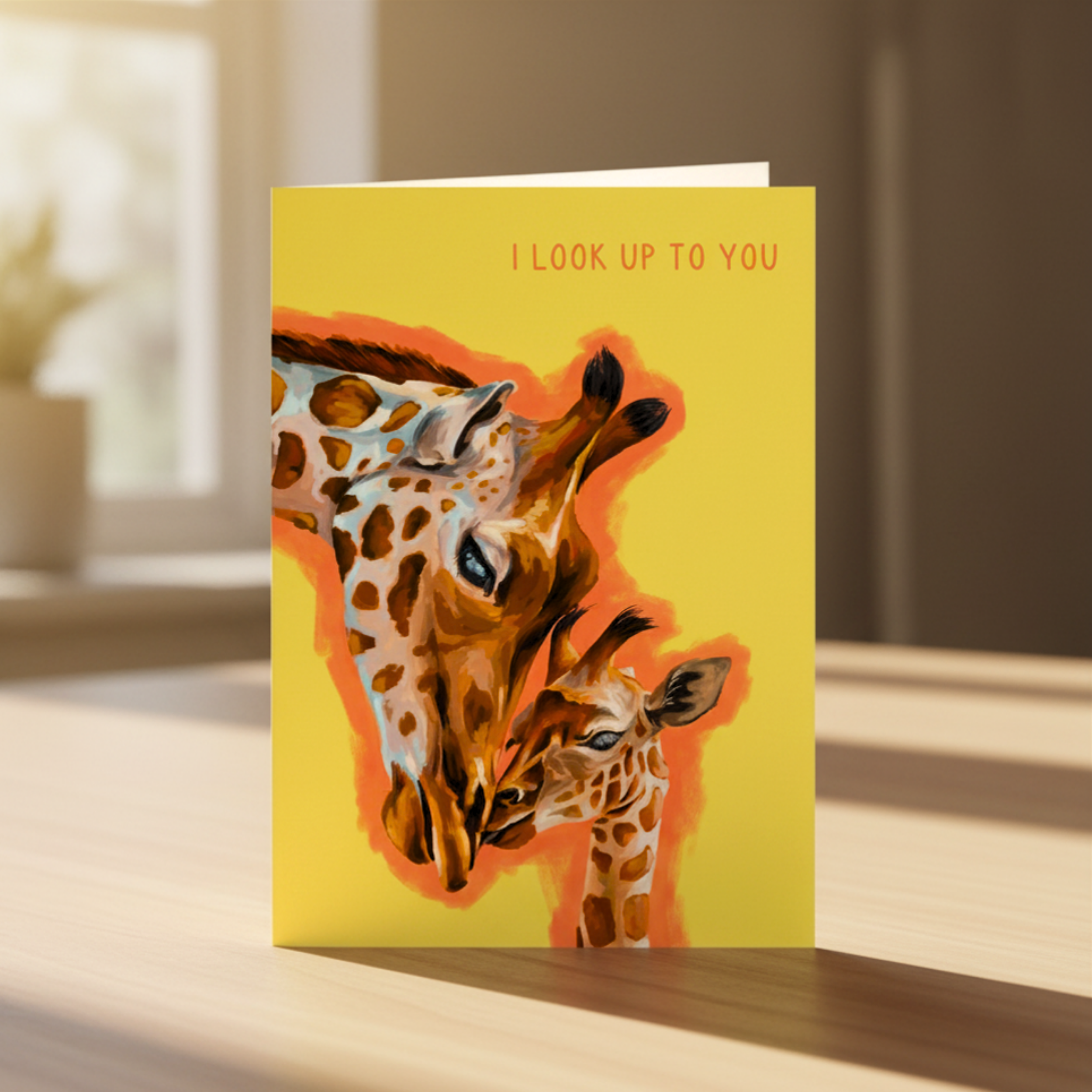 Greeting card with giraffe illustration and text 'I look up to you' on a yellow background