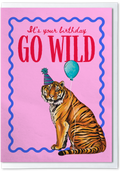 Birthday card with a tiger holding a balloon and text 'It's your birthday GO WILD' on a pink background.