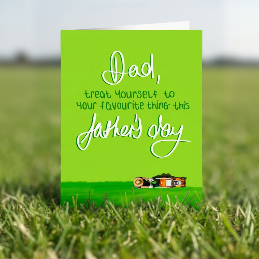Father's Day card with funny message and lawn mower illustration on a green background stood in the grass