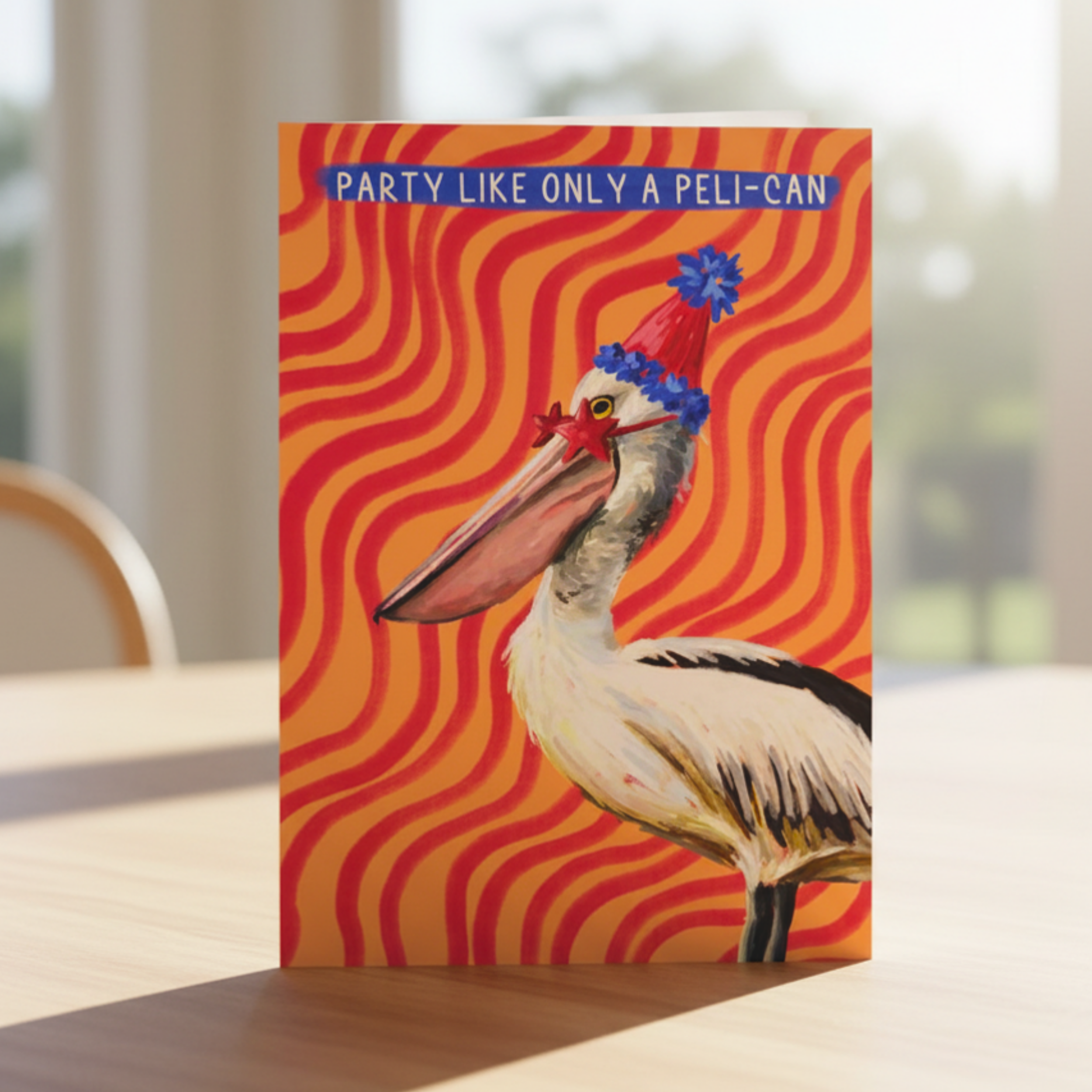 Card with a pelican wearing a party hat on a red and orange wavy background