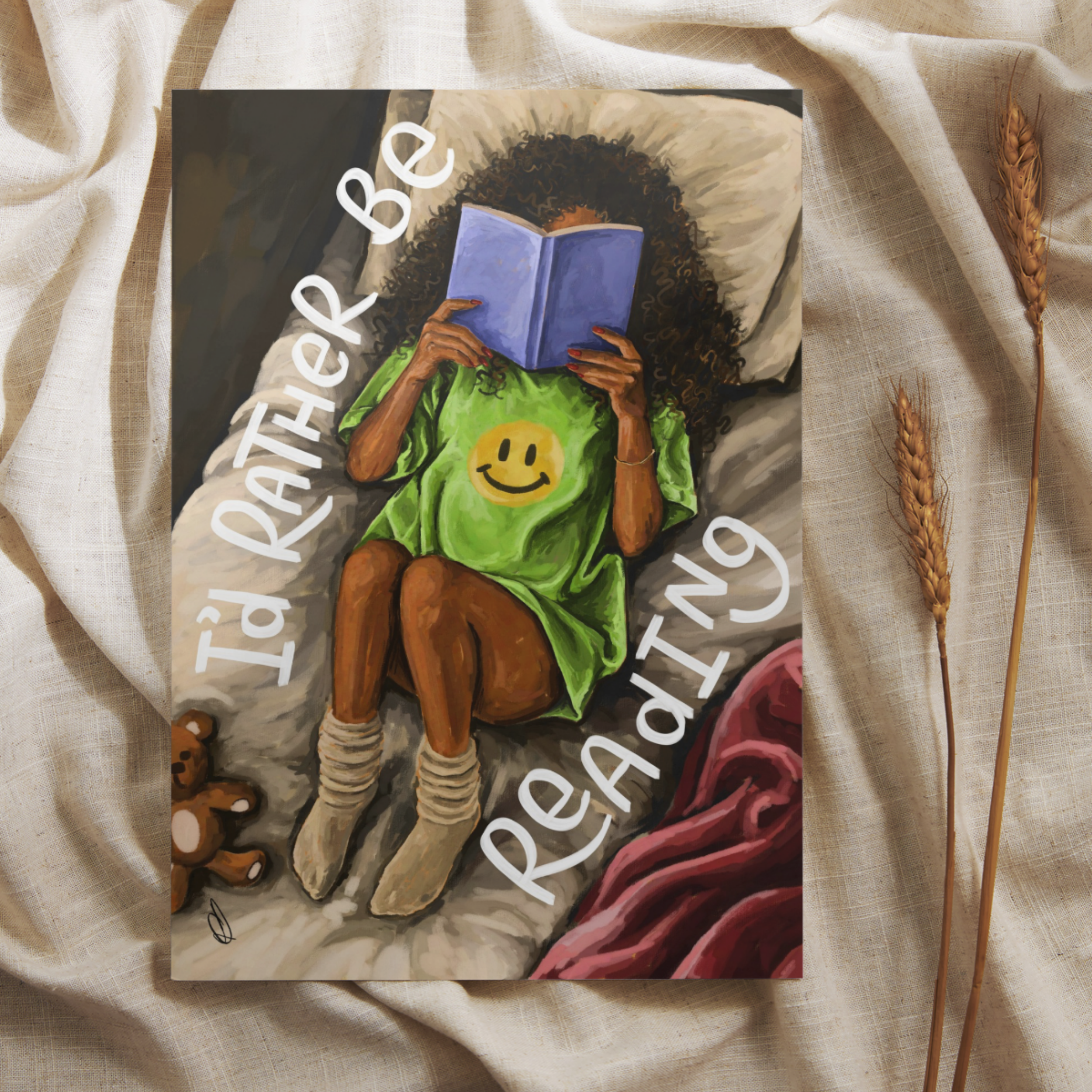 Art print of a cosy girl reading in bed with 'I’d rather be reading' text, placed on a neutral background