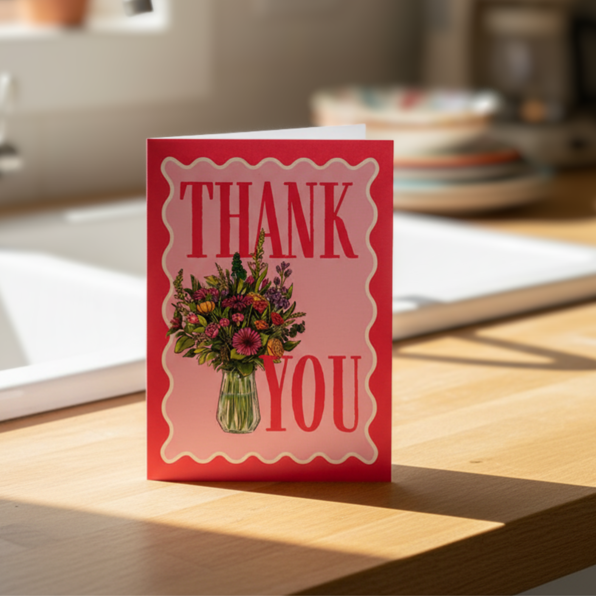 Greeting card with flowers and 'Thank You' text on a  kitchen counter