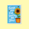 blue greeting card with sunflower and tee illustration and ‘thank you for helping me grow’ message on a yellow background