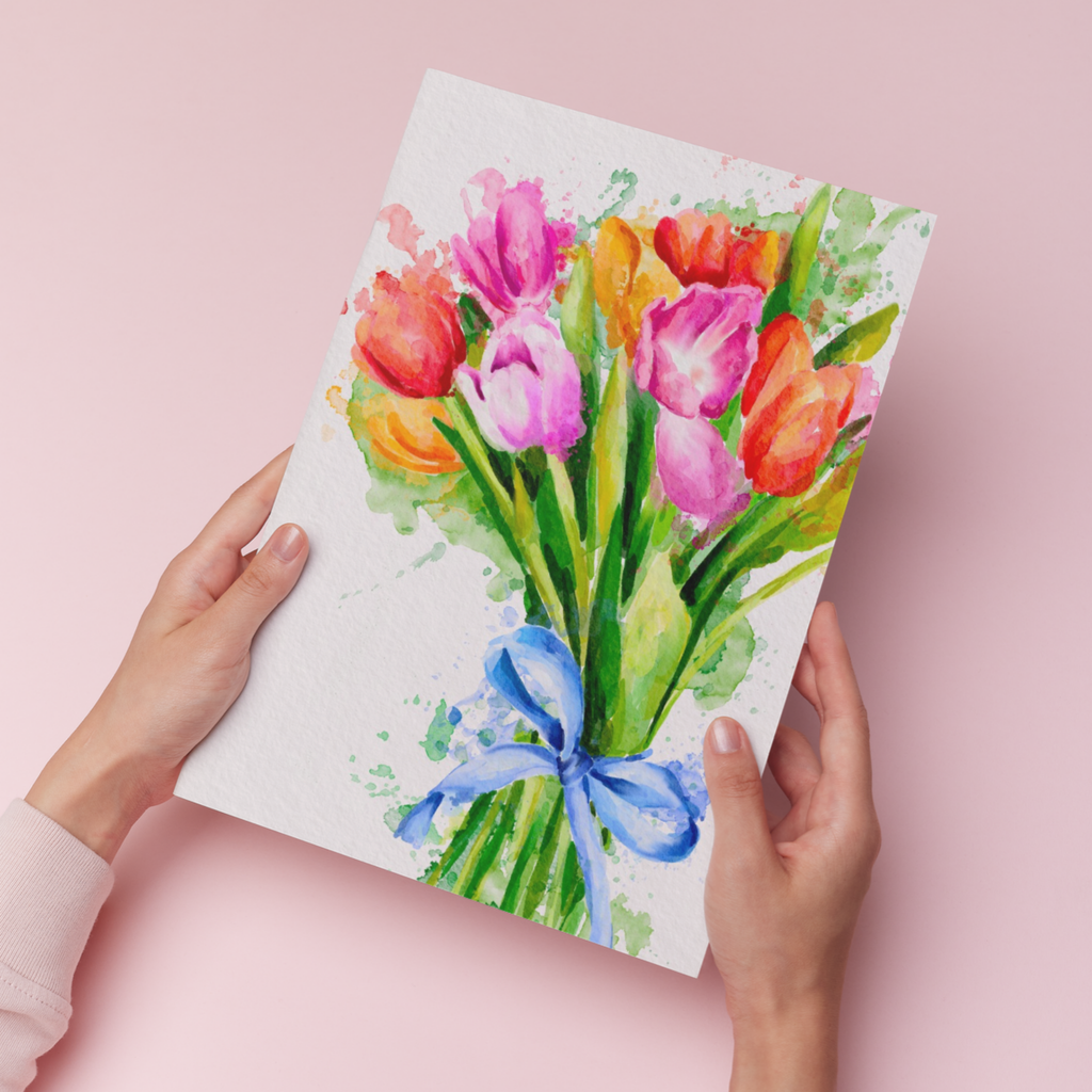 hands holding an art print of watercolour tulips