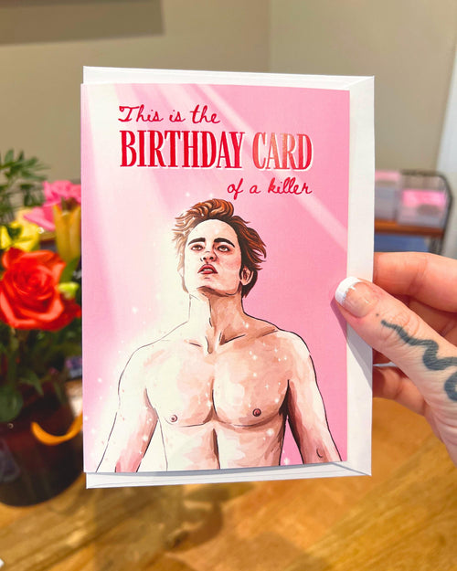 pink birthday card with ‘this is the birthday card of a killer’ and Edward illustration